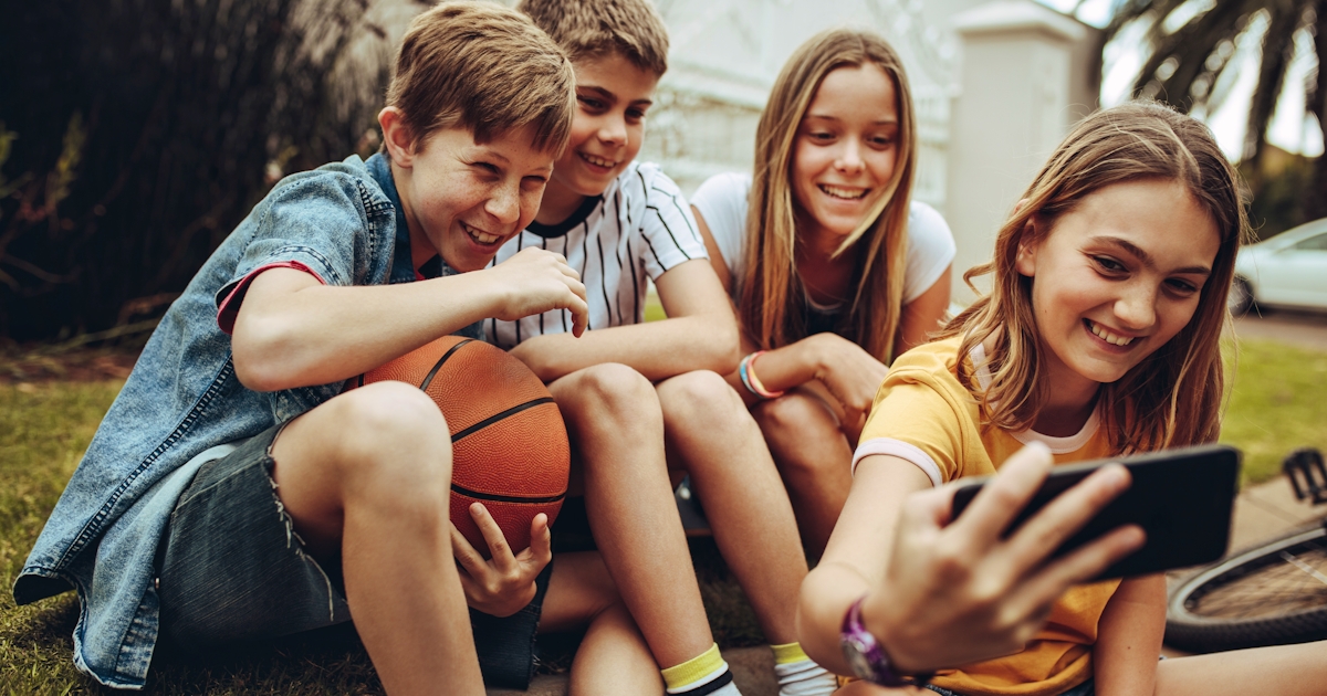 Kids taking a selfie sitting outdoors