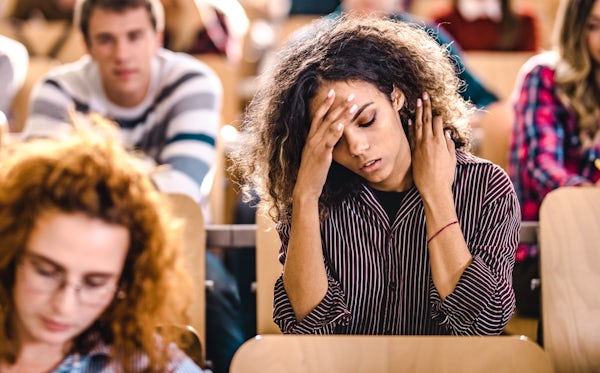 Young university student having a headache on a cl